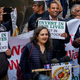 Bhairavi Desai of the New York Taxi Workers Alliance protests Uber and its investors by the Wall Street charging bull